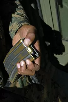 Blanks Gallery: A Marine loads blank ammunition rounds into a magazine