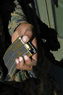 A Marine loads blank ammunition rounds into a magazine A Marine loads blank ammunition rounds into a magazine