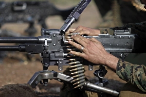 A Marine loads a M-240G machine gun A Marine loads a M-240G machine gun