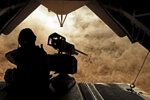 A Marine waits for dust to clear while sitting on a CH-53 Super Stallion A Marine waits for dust to clear while sitting on a CH-53 Super Stallion