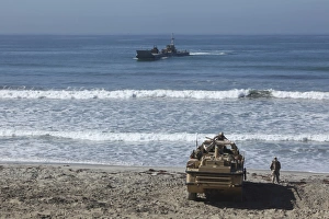 Marines await the arrival of an Improved Navy Lighterage System Marines await the arrival of an Improved Navy Lighterage System