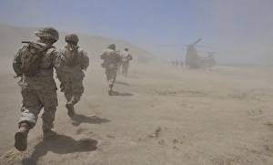 Marines move through a dust cloud toward a CH-46 Sea Knight Marines move through a dust cloud toward a CH-46 Sea Knight
