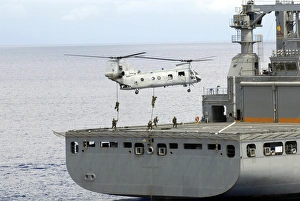 Marines fast rope from a CH-46 Sea Knight helicopter onto the flight deck of USNS Marines fast rope from a CH-46 Sea Knight helicopter onto the flight deck of USNS