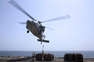 Marines hook cargo to an MH-60S Sea Hawk helicopter Marines hook cargo to an MH-60S Sea Hawk helicopter