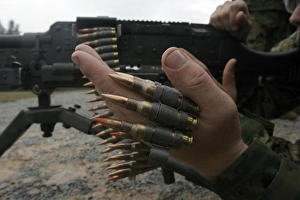 Marines prepare the M-240G medium machine gun with 7.62 mm rounds Marines prepare the M-240G medium machine gun with 7.62 mm rounds