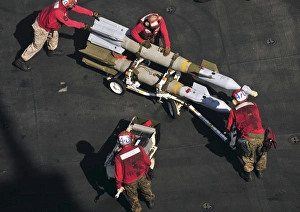 Marines push pordnance into place on the flight deck of USS Enterprise Marines push pordnance into place on the flight deck of USS Enterprise