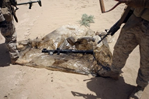 Marines stand over a rocket-propelled grenade launcher Marines stand over a rocket-propelled grenade launcher
