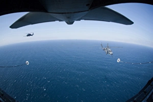 An MC-130P Combat Shadow prepares to refuel two HH-60G Pave Hawk helicopters An MC-130P Combat Shadow prepares to refuel two HH-60G Pave Hawk helicopters