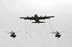 A MC-130W conducts an in-flight refueling for two MH-53J Pave Low III helicopters A MC-130W conducts an in-flight refueling for two MH-53J Pave Low III helicopters