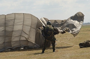 A member of the Pathfinder Platoon collapses his parachute after a HALO jump A member of the Pathfinder Platoon collapses his parachute after a HALO jump