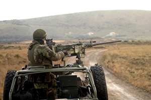A member of the Pathfinder Platoon fires a heavy machine gun atop a Land Rover A member of the Pathfinder Platoon fires a heavy machine gun atop a Land Rover