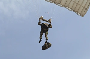 A member of the Pathfinder Platoon prepares to land from a parachute jump A member of the Pathfinder Platoon prepares to land from a parachute jump