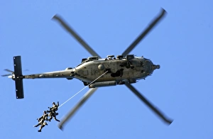 Members conduct a helicopter rope suspension techniques exercise from a SH-60F Seahawk Members conduct a helicopter rope suspension techniques exercise from a SH-60F Seahawk