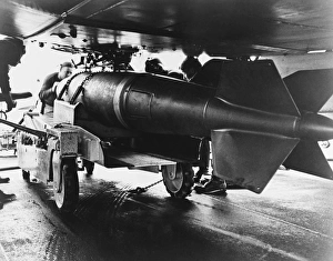 Men aboardUSS Ranger position a 2, 000 pound bomb under the wing of an A-1 Skyraider, 1965 Men aboardUSS Ranger position a 2, 000 pound bomb under the wing of an A-1 Skyraider, 1965