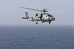 An MH-60R Sea Hawk helicopter flies over the Gulf of Oman An MH-60R Sea Hawk helicopter flies over the Gulf of Oman