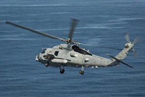 An MH-60R Sea Hawk maneuvers over the South China Sea An MH-60R Sea Hawk maneuvers over the South China Sea