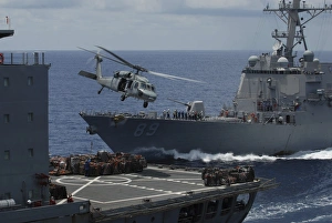 An MH-60S Knighthawk helicopter transports a pallet of supplies to USS Essex An MH-60S Knighthawk helicopter transports a pallet of supplies to USS Essex