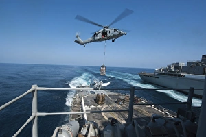 An MH-60S Sea Hawk brings pallets of supplies to USS Mobile Bay An MH-60S Sea Hawk brings pallets of supplies to USS Mobile Bay