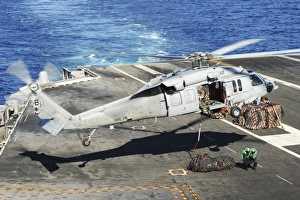 An MH-60S Sea Hawk helicopter conducts a vertical replenishment An MH-60S Sea Hawk helicopter conducts a vertical replenishment