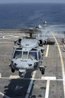 Two MH-60S Sea Hawk helicopters take off from USS Ponce Two MH-60S Sea Hawk helicopters take off from USS Ponce