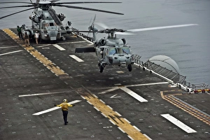 An MH-60S Sea Hawk lands aboard the amphibious assault ship USS Makin Island An MH-60S Sea Hawk lands aboard the amphibious assault ship USS Makin Island