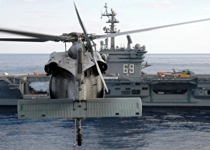 An MH-60S Seahawk hovers prior to taking a load of ammunition to USS Dwight D. Eisenhower An MH-60S Seahawk hovers prior to taking a load of ammunition to USS Dwight D. Eisenhower