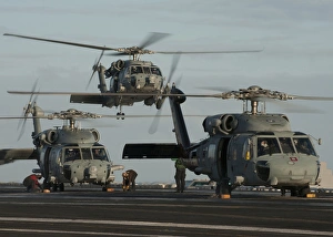 Military helicopters land on the flight deck of USS Carl Vinson Military helicopters land on the flight deck of USS Carl Vinson
