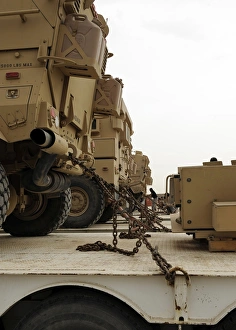 Military vehicles are locked down on semi trucks Military vehicles are locked down on semi trucks
