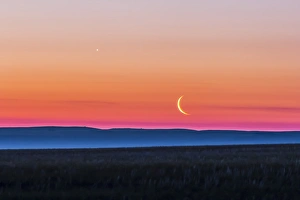 Moon and Venus rising over the flat prairie horizon of Alberta, Canada Moon and Venus rising over the flat prairie horizon of Alberta, Canada