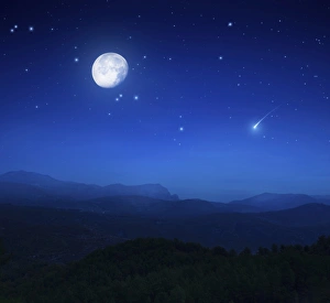 Mountain range on a misty night with moon, starry sky and falling meteorite Mountain range on a misty night with moon, starry sky and falling meteorite