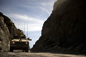 A MRAP vehicle drives through the mountains of Afghanistan A MRAP vehicle drives through the mountains of Afghanistan
