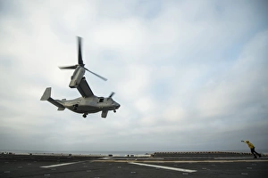 An MV-22 Osprey is guided onto the flight deck of USS Boxer An MV-22 Osprey is guided onto the flight deck of USS Boxer
