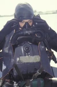 Life Jackets Gallery: A Navy SEAL combat swimmer adjusts his dive mask