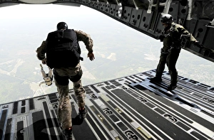 Navy SEALs jump from the ramp of a C-17 Globemaster III over Virginia Navy SEALs jump from the ramp of a C-17 Globemaster III over Virginia