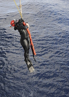 An Operations Specialist is lifted out of the ocean An Operations Specialist is lifted out of the ocean