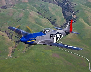 A P-51D Mustang in flight over Hollister, California A P-51D Mustang in flight over Hollister, California