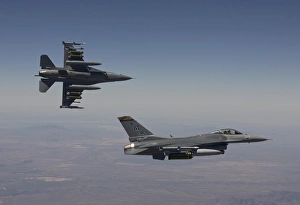 A pair of F-16s fly in formation over Arizona A pair of F-16s fly in formation over Arizona