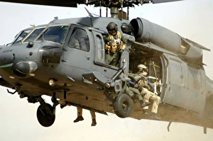 Pararescuemen aboard a helicopter prepare for landing Pararescuemen aboard a helicopter prepare for landing