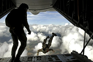 Pararescuemen jump out the back of a C-130 Hercules Pararescuemen jump out the back of a C-130 Hercules