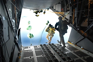 Pararescuemen perform a static-line jump out of a C-130 Hercules Pararescuemen perform a static-line jump out of a C-130 Hercules