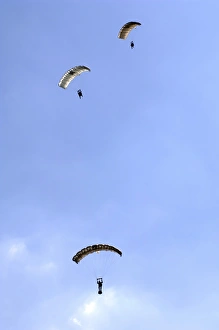 Paratroopers from the Pathfinder Platoon descend through the sky Paratroopers from the Pathfinder Platoon descend through the sky