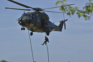 A pathfinder of the Belgian Army fast-roping from a NH90 helicopter A pathfinder of the Belgian Army fast-roping from a NH90 helicopter