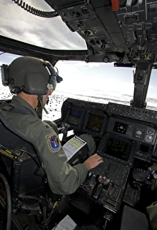 Pilot of a CV-22 Osprey goes over his instruments in the cockpit Pilot of a CV-22 Osprey goes over his instruments in the cockpit