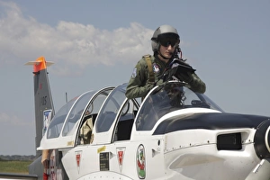 Pilot standing in a Socata TB-30 Epsilon trainer aircraft Pilot standing in a Socata TB-30 Epsilon trainer aircraft
