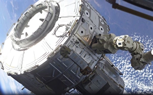 The Quest Airlock is maneuvered into the proper position to be mated onto the starboard The Quest Airlock is maneuvered into the proper position to be mated onto the starboard