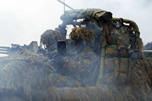 A recce or scout team of the Belgian Army in action under a smoke curtain A recce or scout team of the Belgian Army in action under a smoke curtain