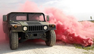 Red smoke billows out onto a humvee Red smoke billows out onto a humvee