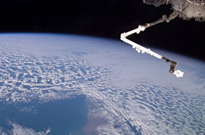 <b class=qtipBold><figcaption>The robotic Canadarm2 above Earth</figcaption></b><br>June 30, 2005 - The Expedition 11 crew aboard the International Space Station flexes the robotic arm, Canadarm2, while flying approximately 225 miles above Cape Horn.<br><em>© Stocktrek Images</em> The robotic Canadarm2 above Earth