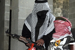A role-playing enemy aggressor arms a dummy with a simulated AK-47 rifle A role-playing enemy aggressor arms a dummy with a simulated AK-47 rifle
