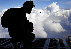 A Romanian paratrooper awaits his signal to jump out of a C-130J Super Hercules A Romanian paratrooper awaits his signal to jump out of a C-130J Super Hercules